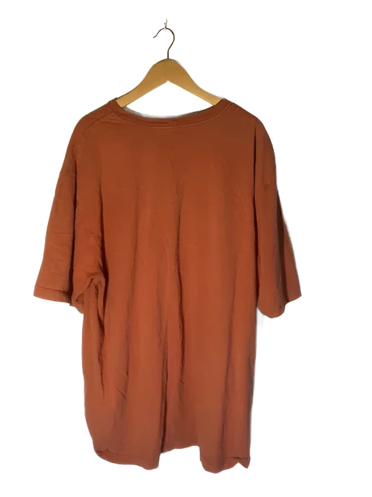 Orange t-shirt on a hanger.