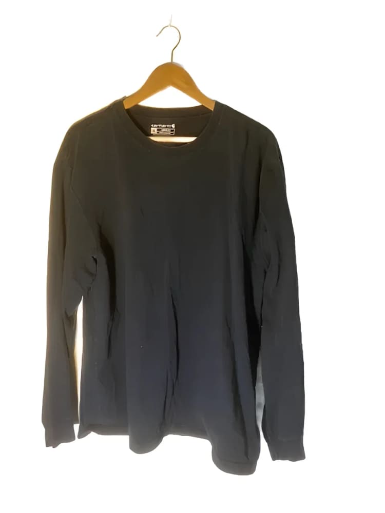 Black long-sleeved shirt on a hanger.