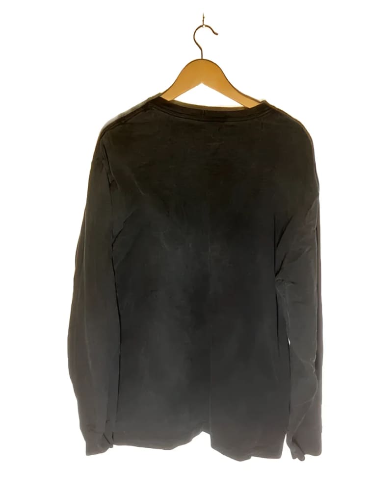 Black long-sleeved shirt on hanger.