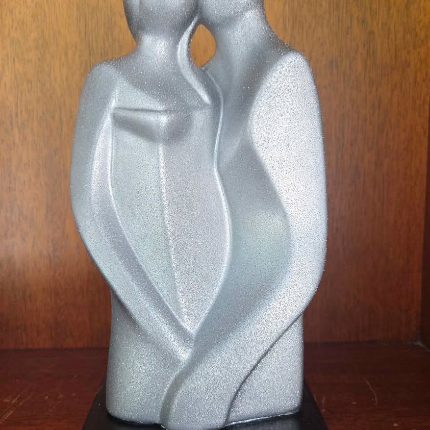 Modern Sculpture, depicting two abstract young couple figures embracing or standing close together.