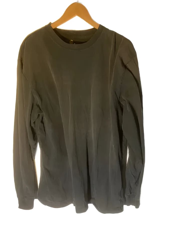 Black long-sleeved shirt on a hanger.