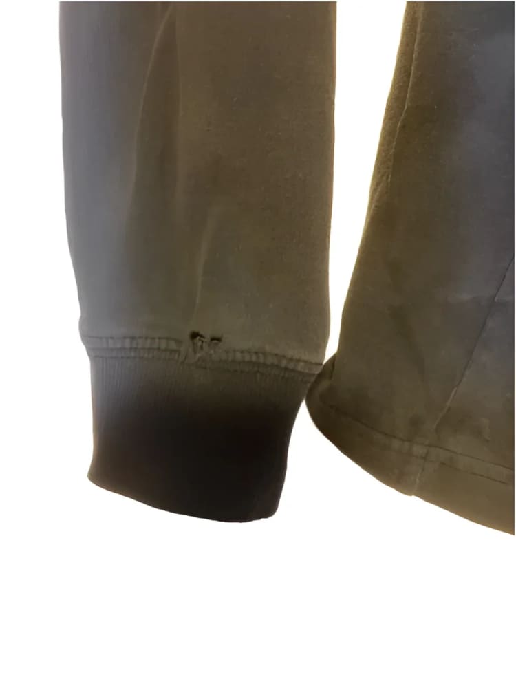 Worn gray sleeve with small holes.