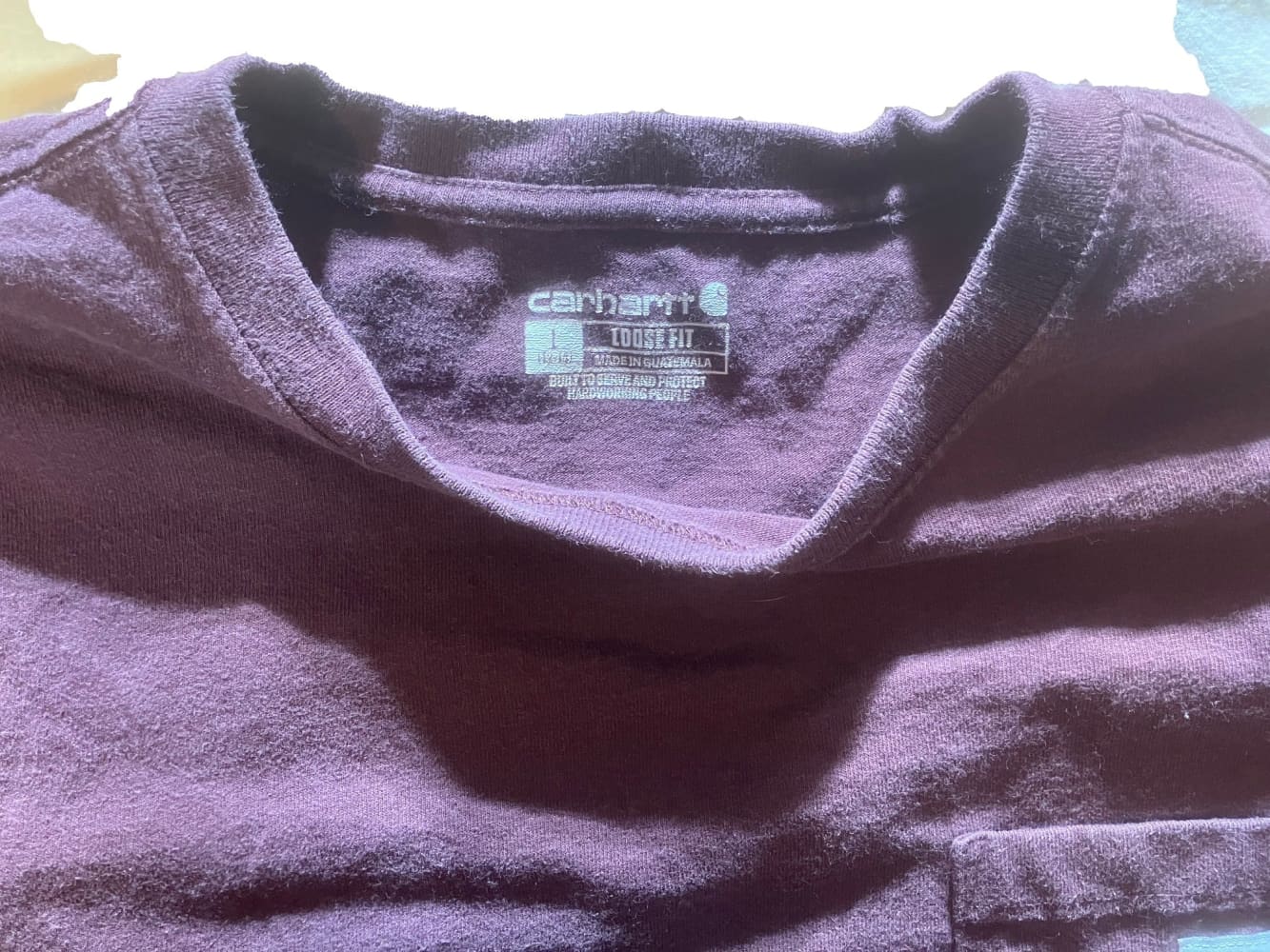 Purple Carhartt long-sleeve t-shirt with a ’Loose Fit’ label.