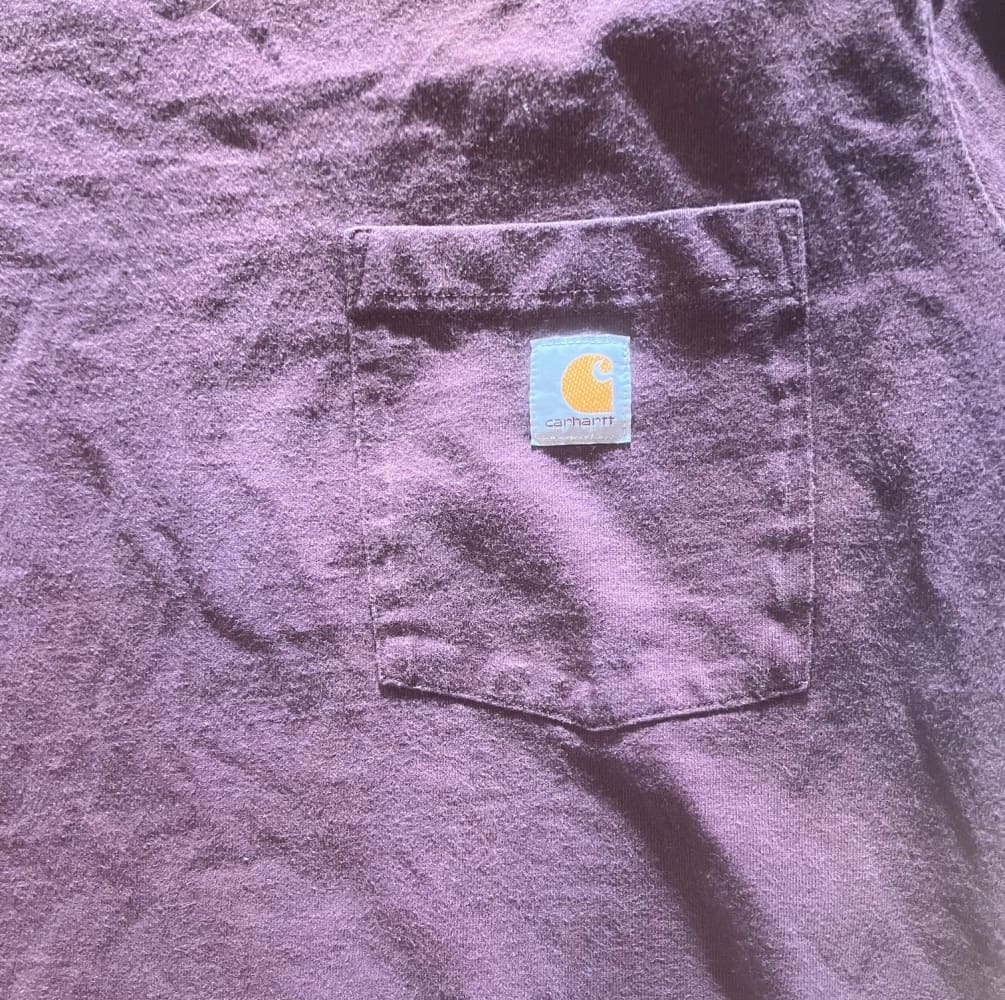 A wrinkled purple T-shirt with a chest pocket.