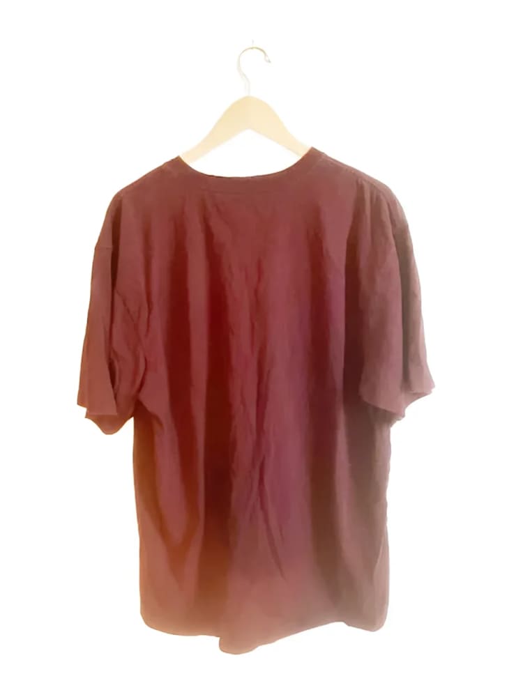 Maroon t-shirt on a hanger.