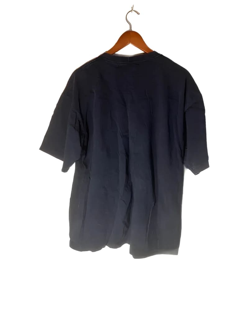 Black short-sleeved t-shirt on a wooden hanger.