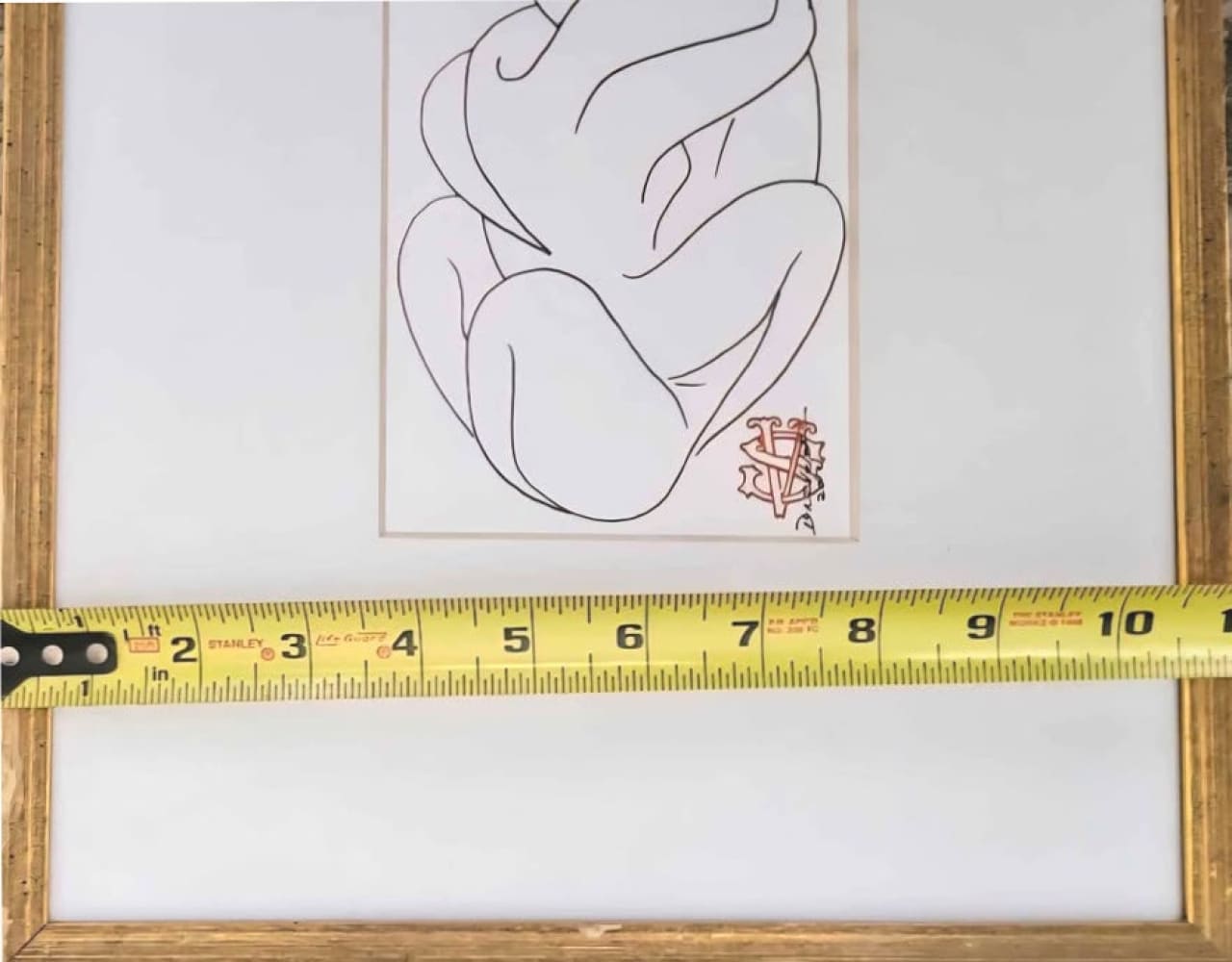 Framed line drawing of a nude figure.