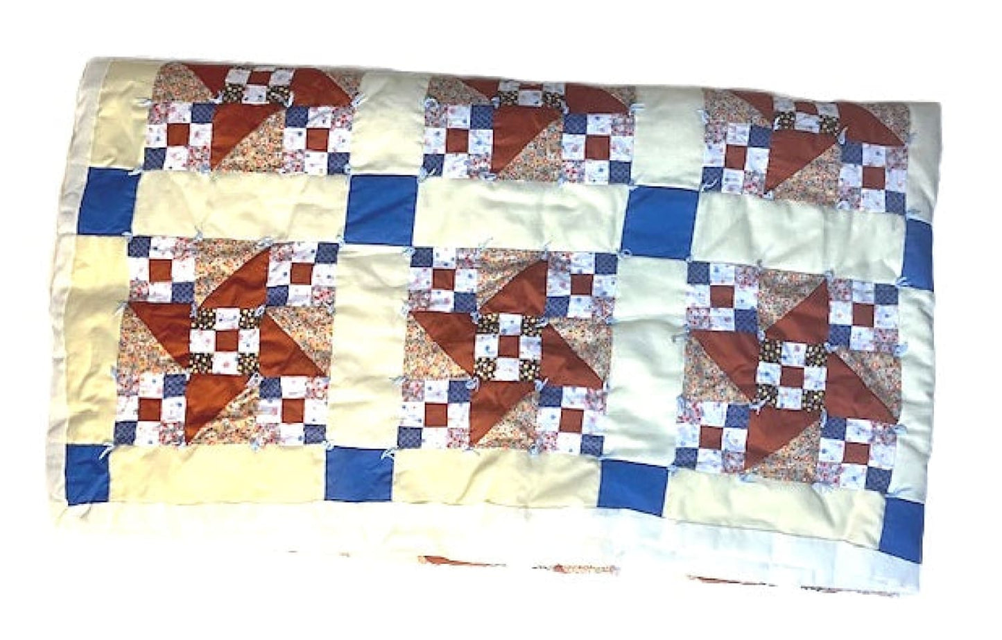 A colorful patchwork quilt with a pinwheel and checkerboard design.