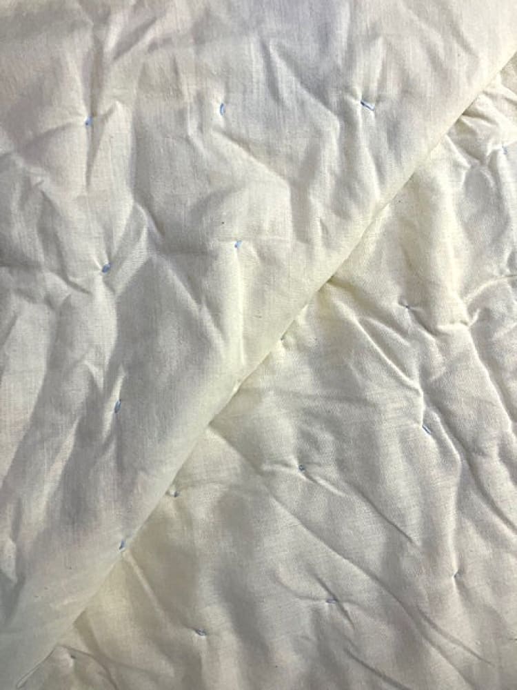 White quilted blanket with light blue stitching.
