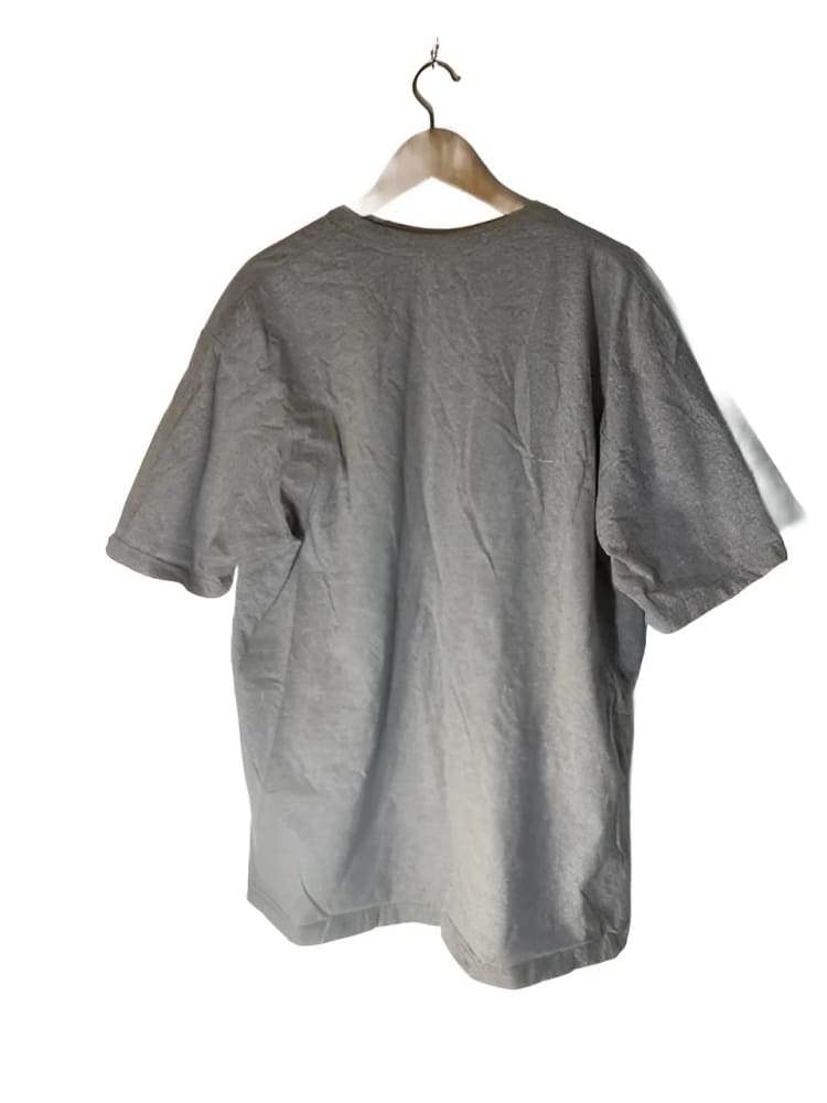 A light brown short-sleeved t-shirt on a wooden hanger.