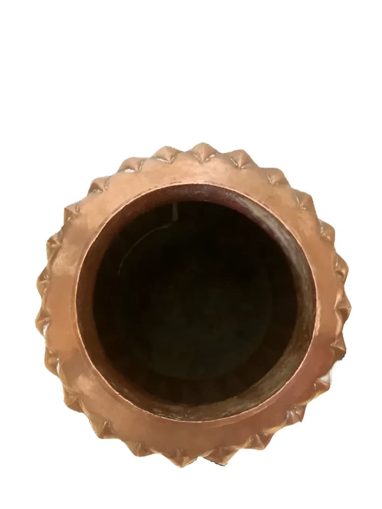 Copper-colored, spiked-rim container.