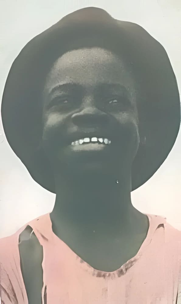 Smiling person wearing a hat.