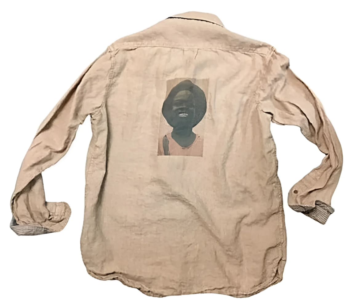 Tan button-down shirt with portrait.