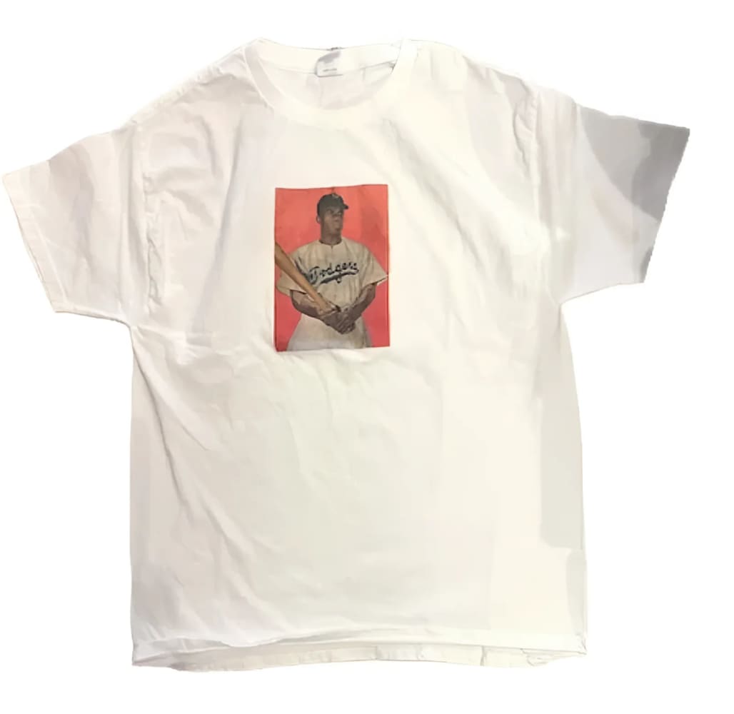 White t-shirt with baseball player graphic.