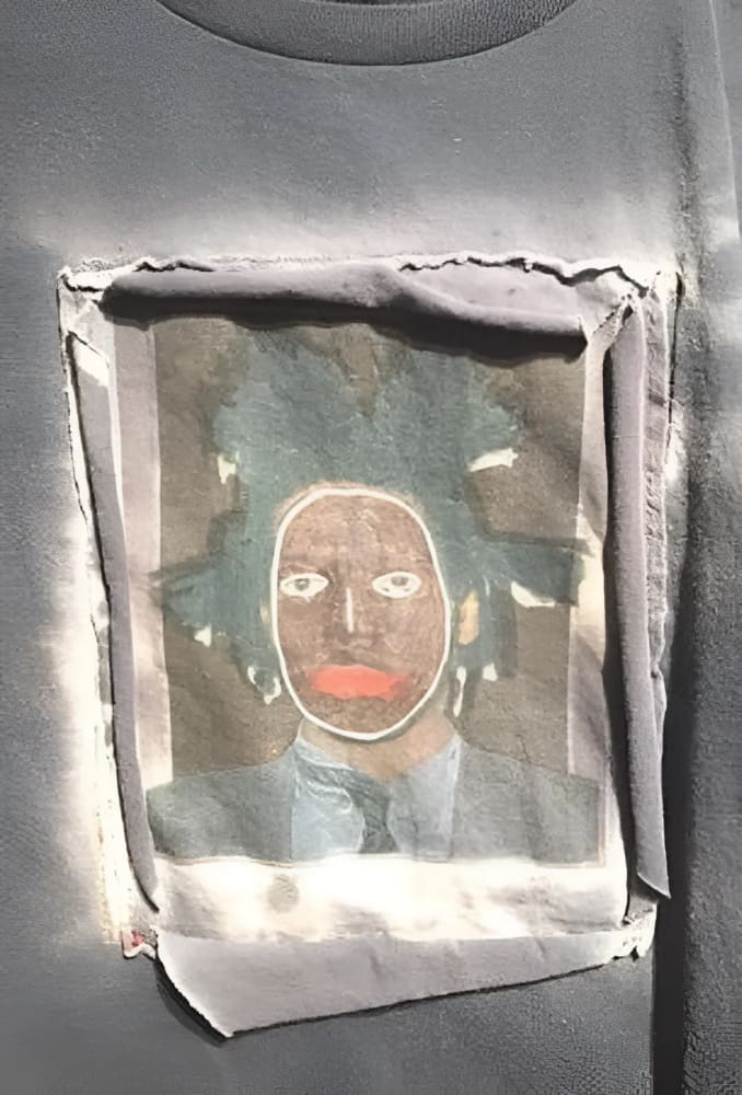 Gray t-shirt with Basquiat portrait patch.