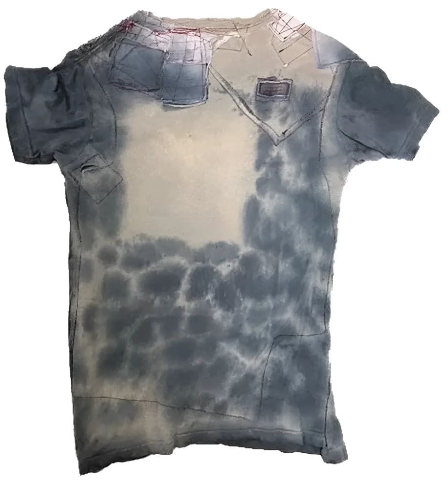 Distressed and patched denim t-shirt.