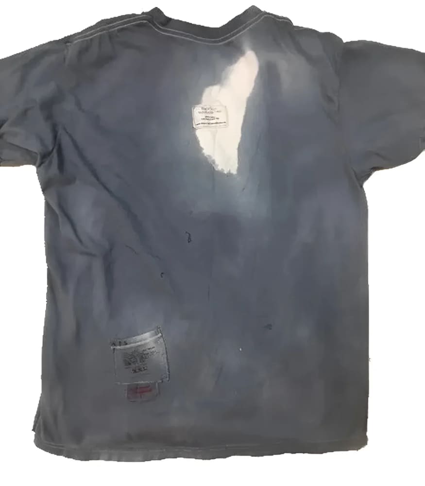 Worn blue t-shirt with bleach stains.