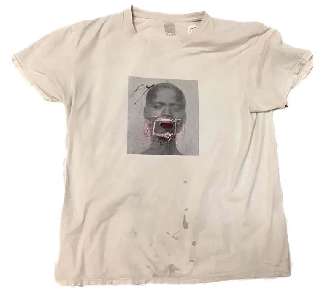 Beige t-shirt with a graphic print.