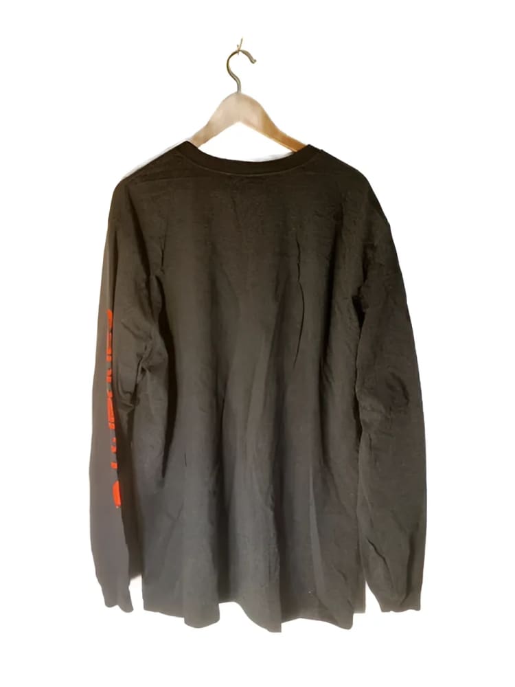 A long-sleeved dark brown or black t-shirt with red writing on the left sleeve.