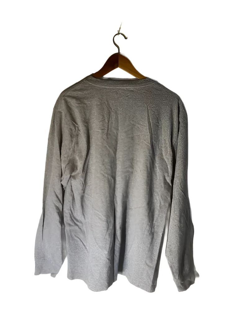 A light gray long-sleeved t-shirt on a wooden hanger.