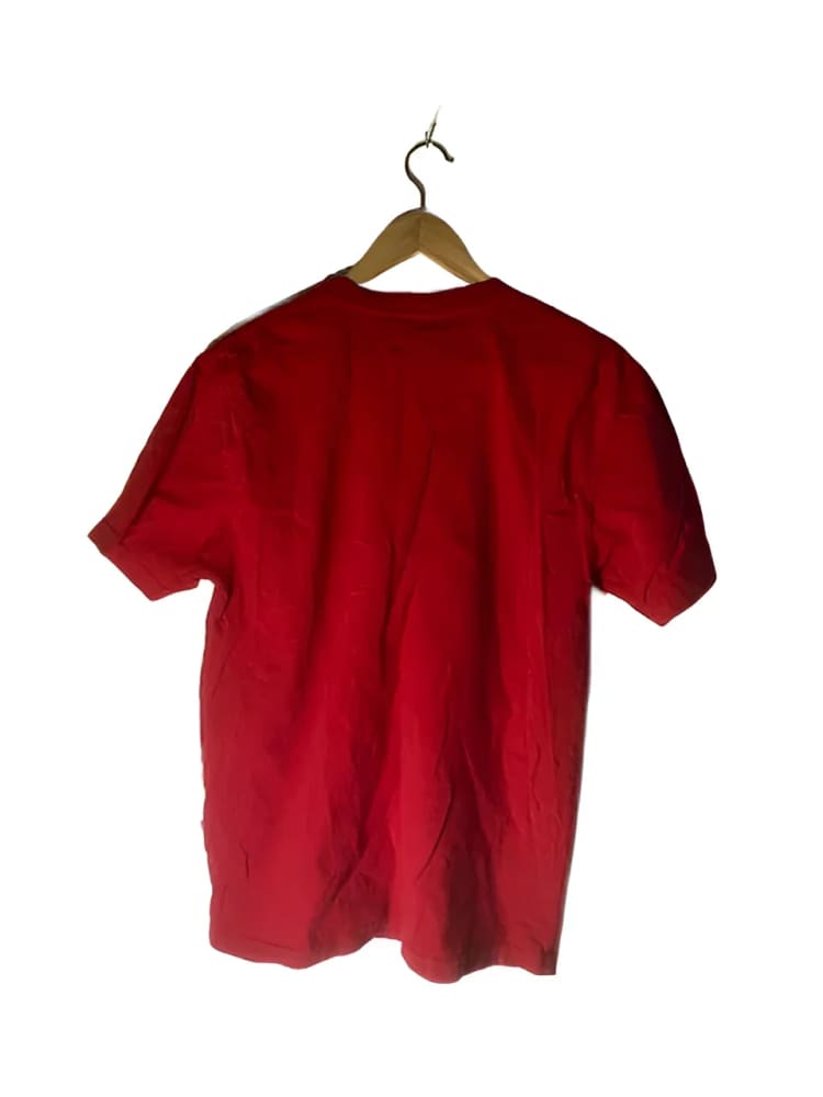 Red short-sleeved t-shirt on a wooden hanger.
