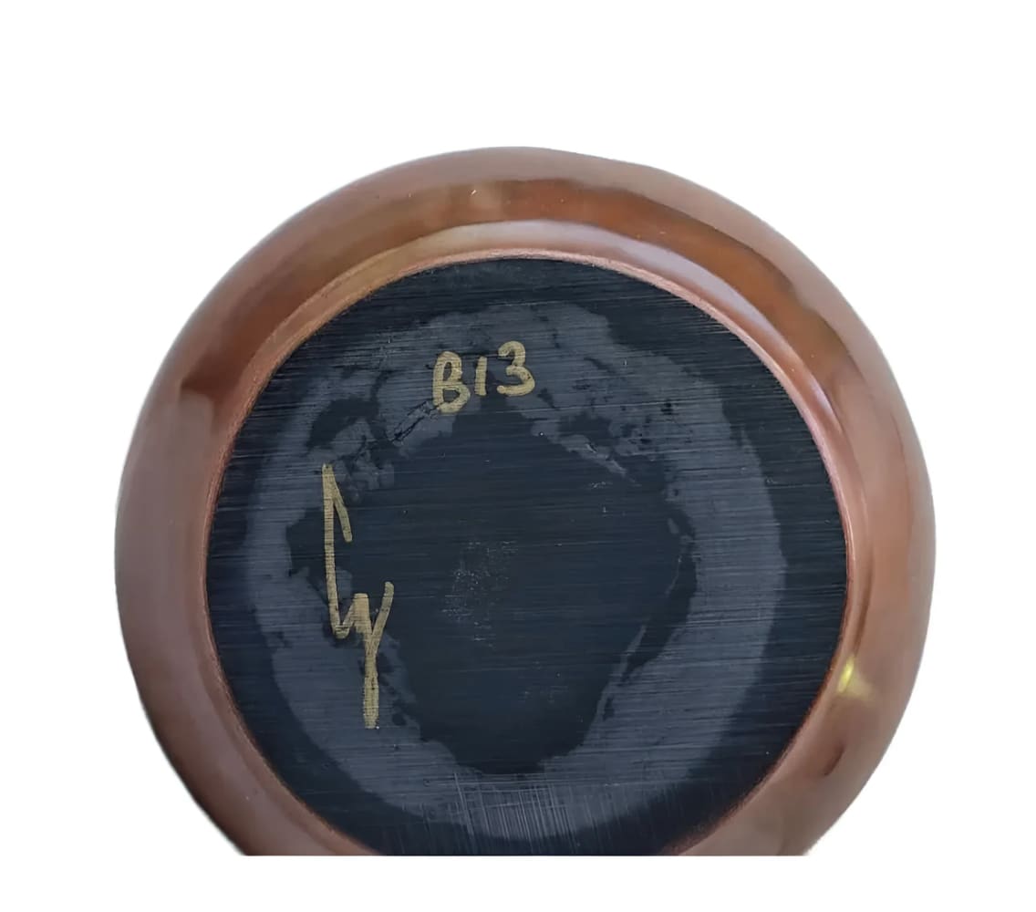 Copper-colored bowl with black interior.