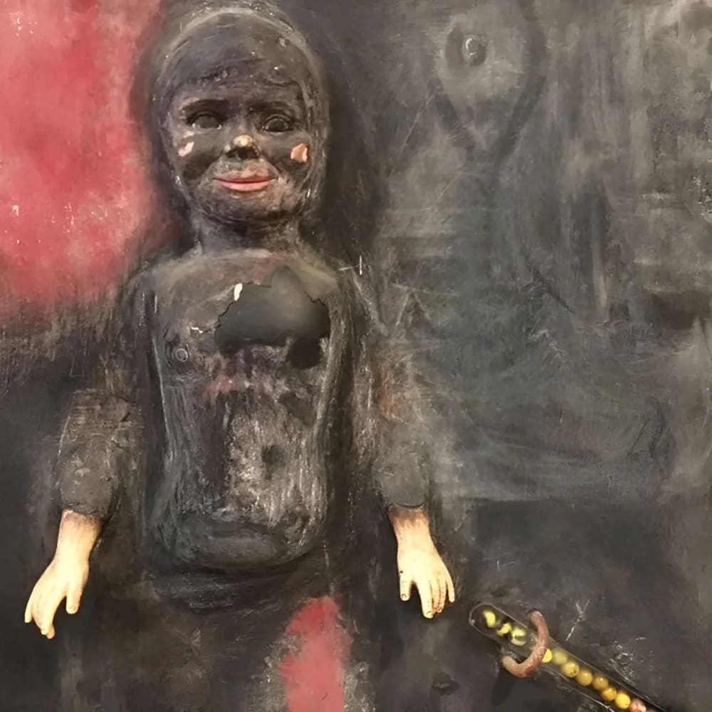 Disturbing, damaged doll sculpture.