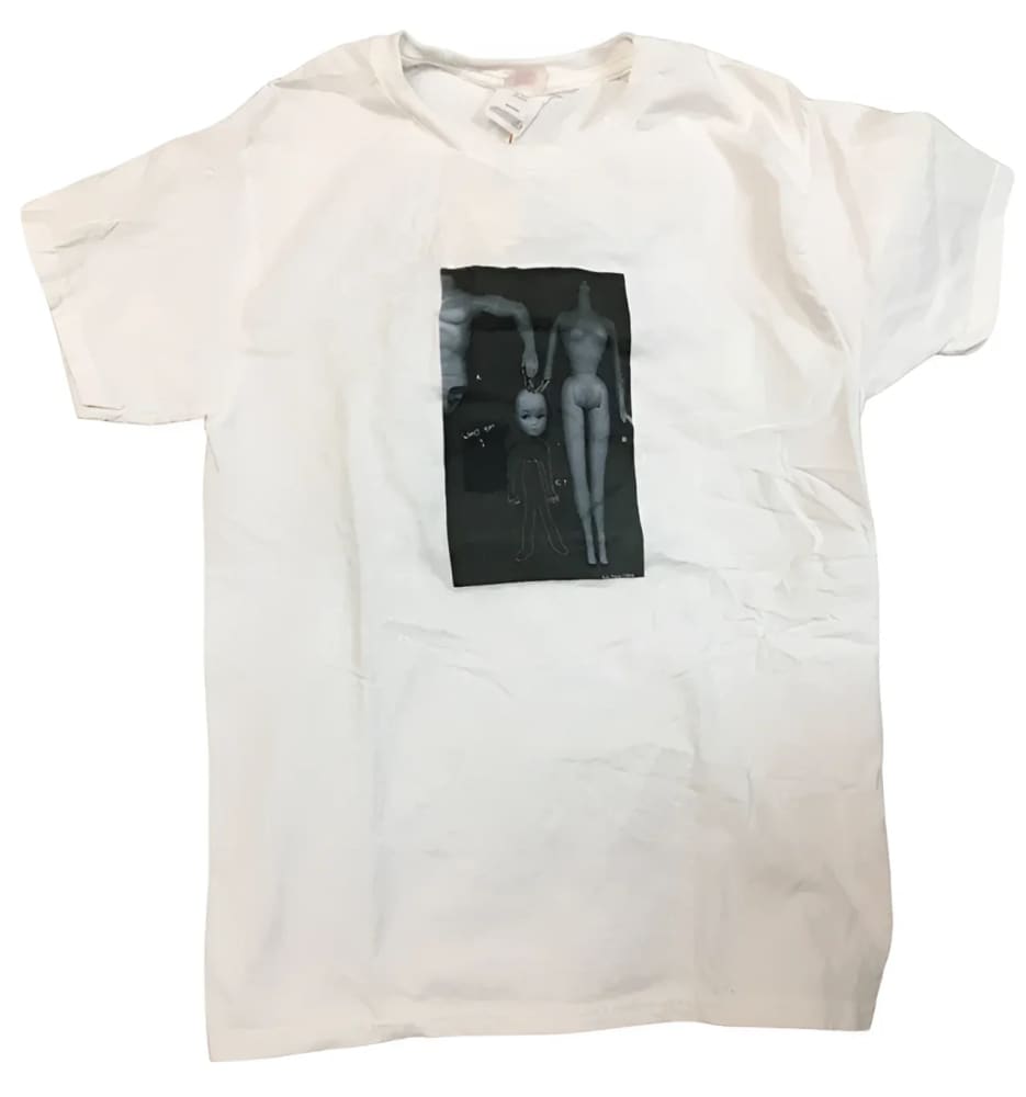 A white crewneck short-sleeved t-shirt with a black and white graphic of two dolls.