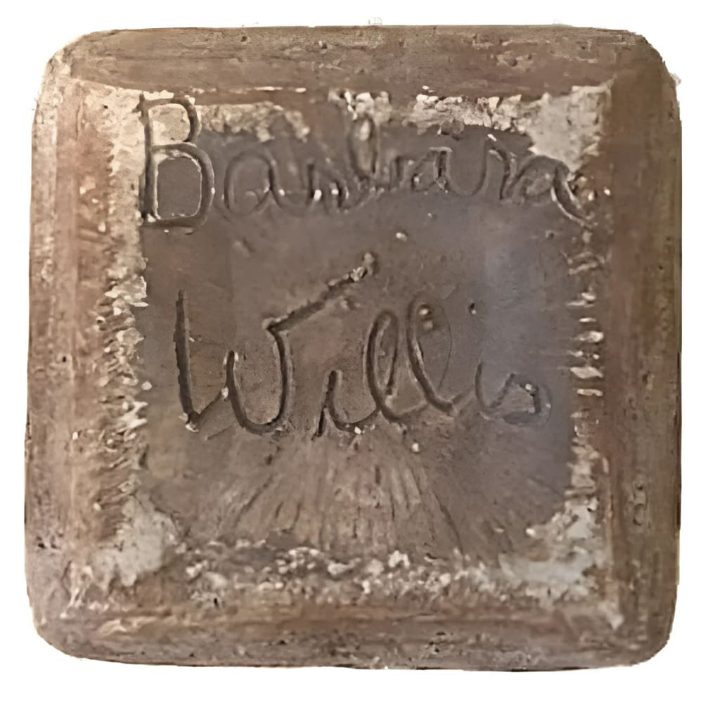 Square, brown, inscribed block.