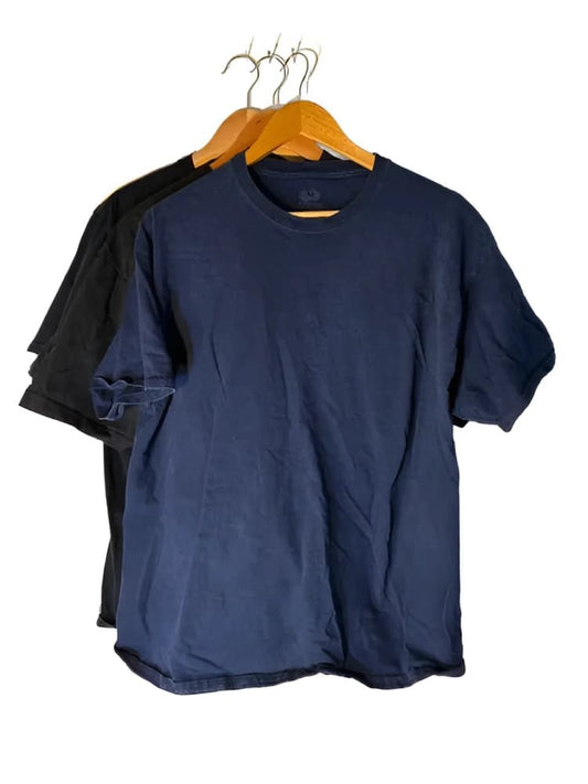 Three short-sleeved t-shirts on wooden hangers.