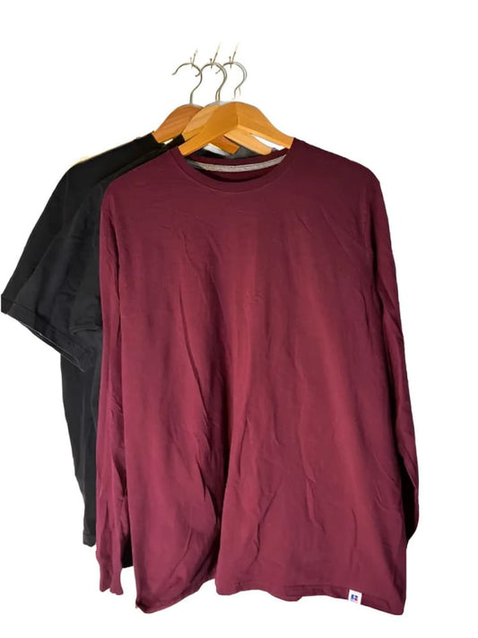 Two long-sleeved shirts, one black and one maroon, hanging on wooden hangers.