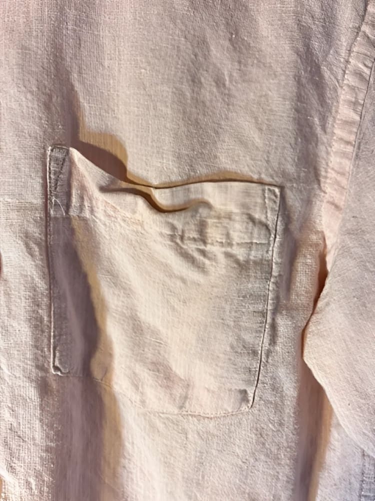 A light pink linen shirt with a single chest pocket.