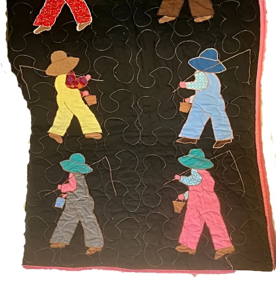 Hand-stitched quilt featuring appliquéd figures of people in overalls and hats, carrying buckets, on a black background with white quilting.