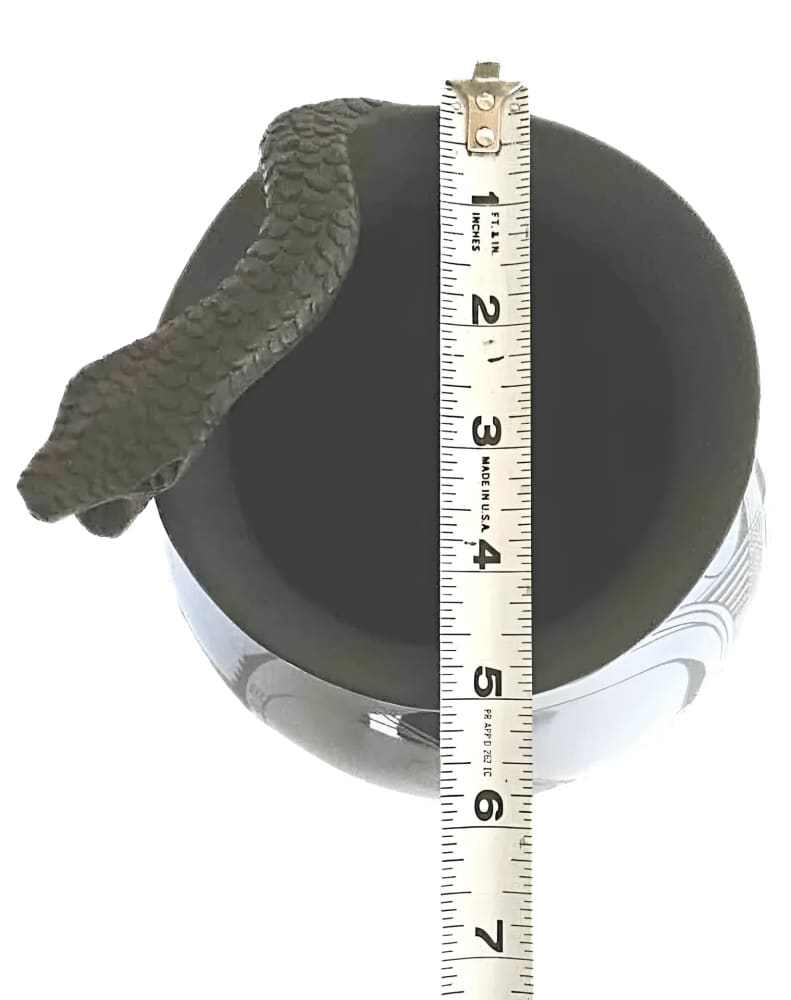 Rita Talavera signed black Mata Ortiz vase with intricate snake motif and 10-inch height shown with measuring tape