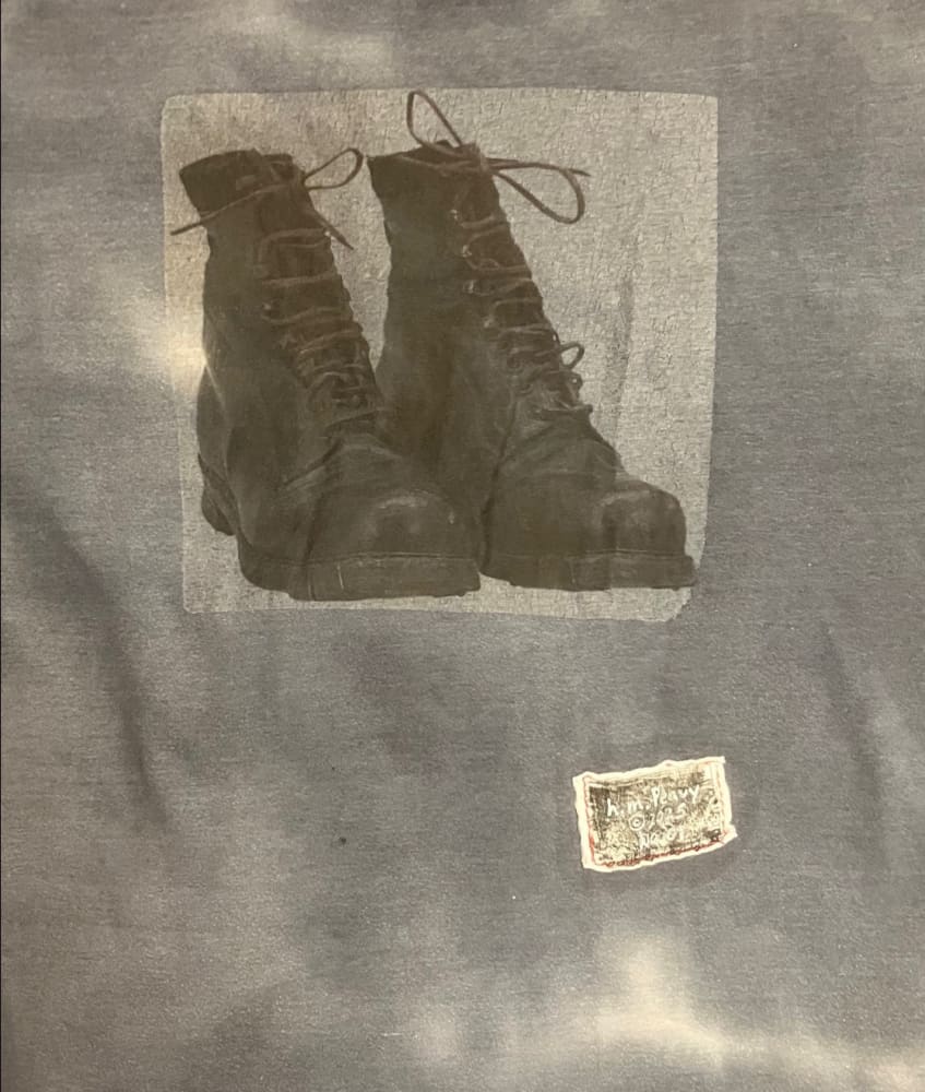 A pair of worn black lace-up boots.