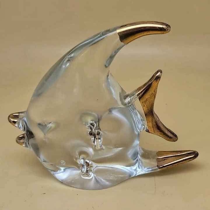This is a beautiful Murano art glass angel fish. The fish is clear glass with gold trim detail.