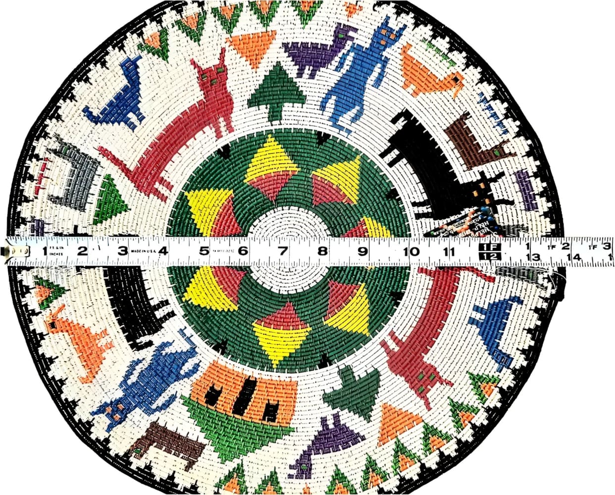 Circular Native American beaded basket with animal and geometric designs.