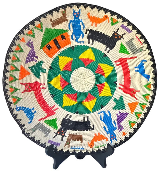 Hand-woven colorful decorative plate with animal and house motifs.
