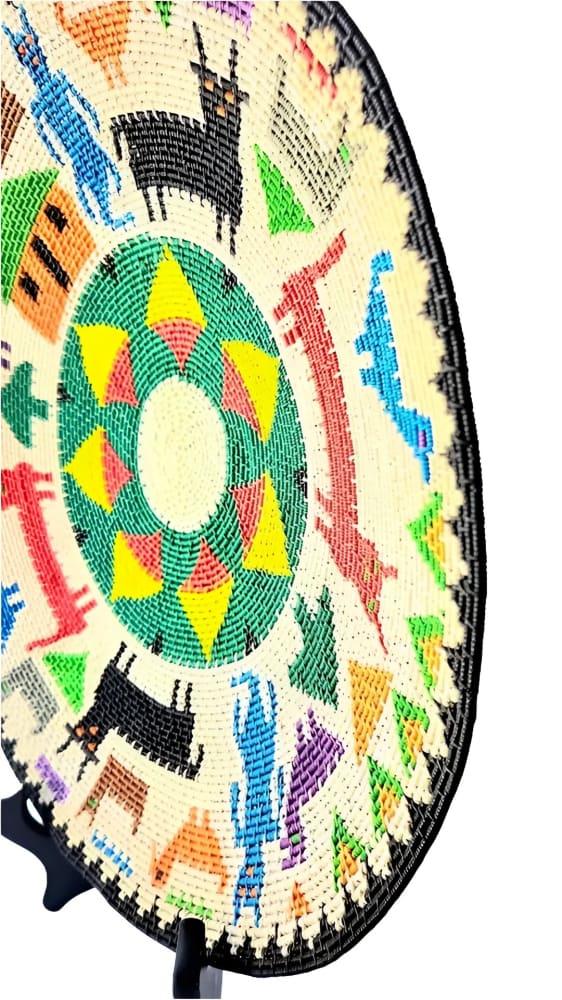 Handwoven decorative plate with colorful animal and geometric designs.