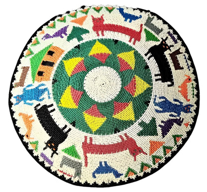 A round, intricately beaded decorative wall hanging or platter with a central geometric design and a border of colorful animal and abstract figures.
