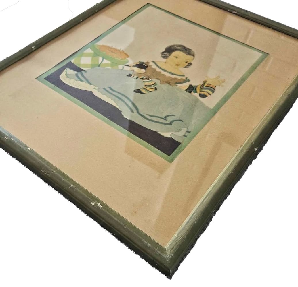 A framed vintage print of a child.