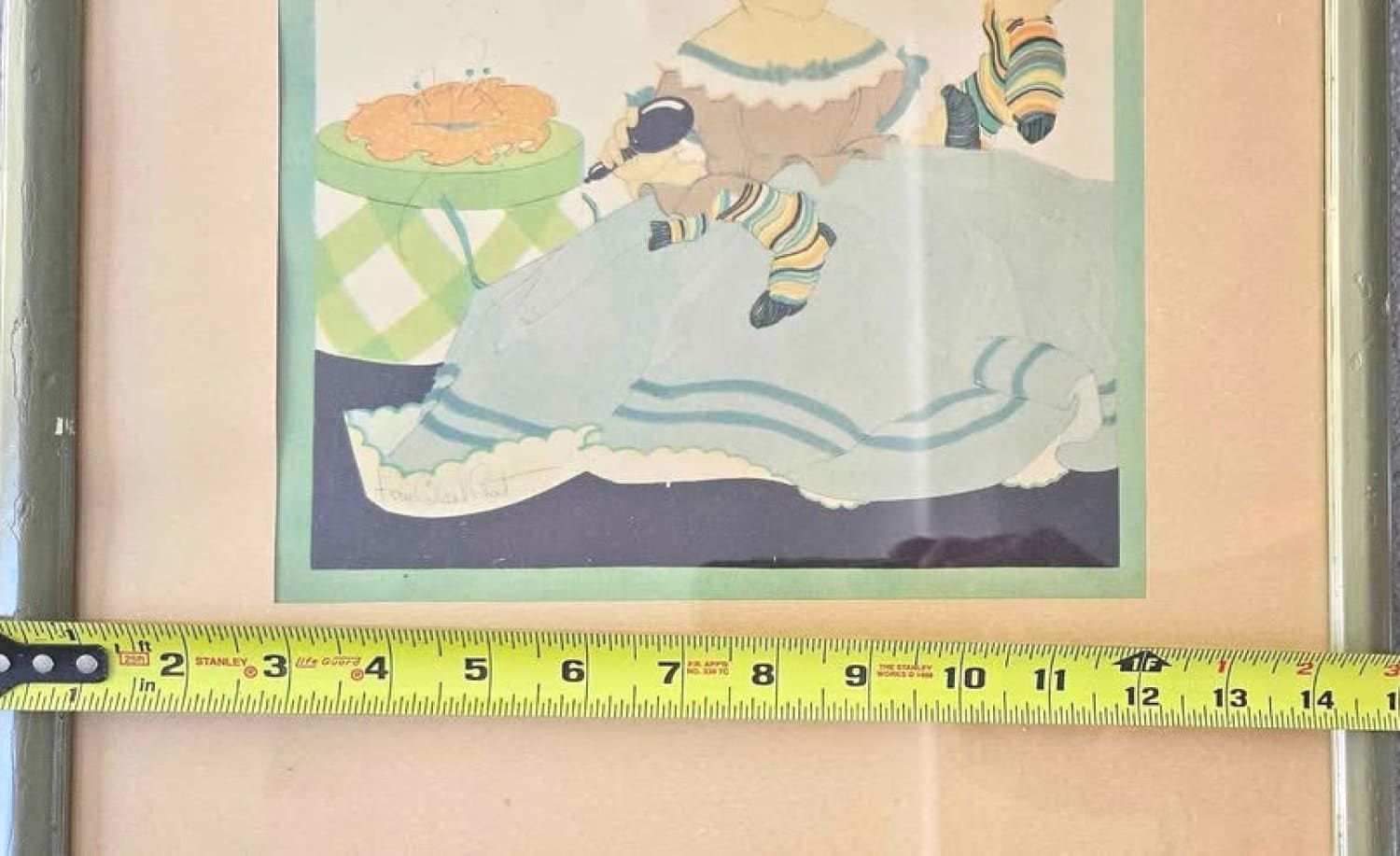 Framed artwork with a measuring tape across the bottom.
