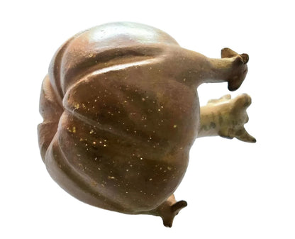 A brown, textured, snail-shaped sculpture with visible appendages.