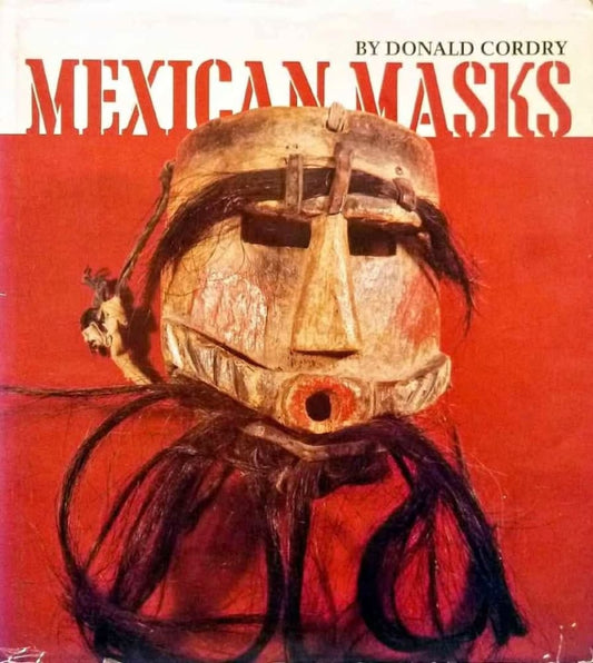 Vintage wooden mask with dark hair accents.