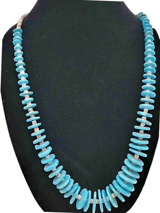 Graduated turquoise heishi bead necklace with clear spacers.