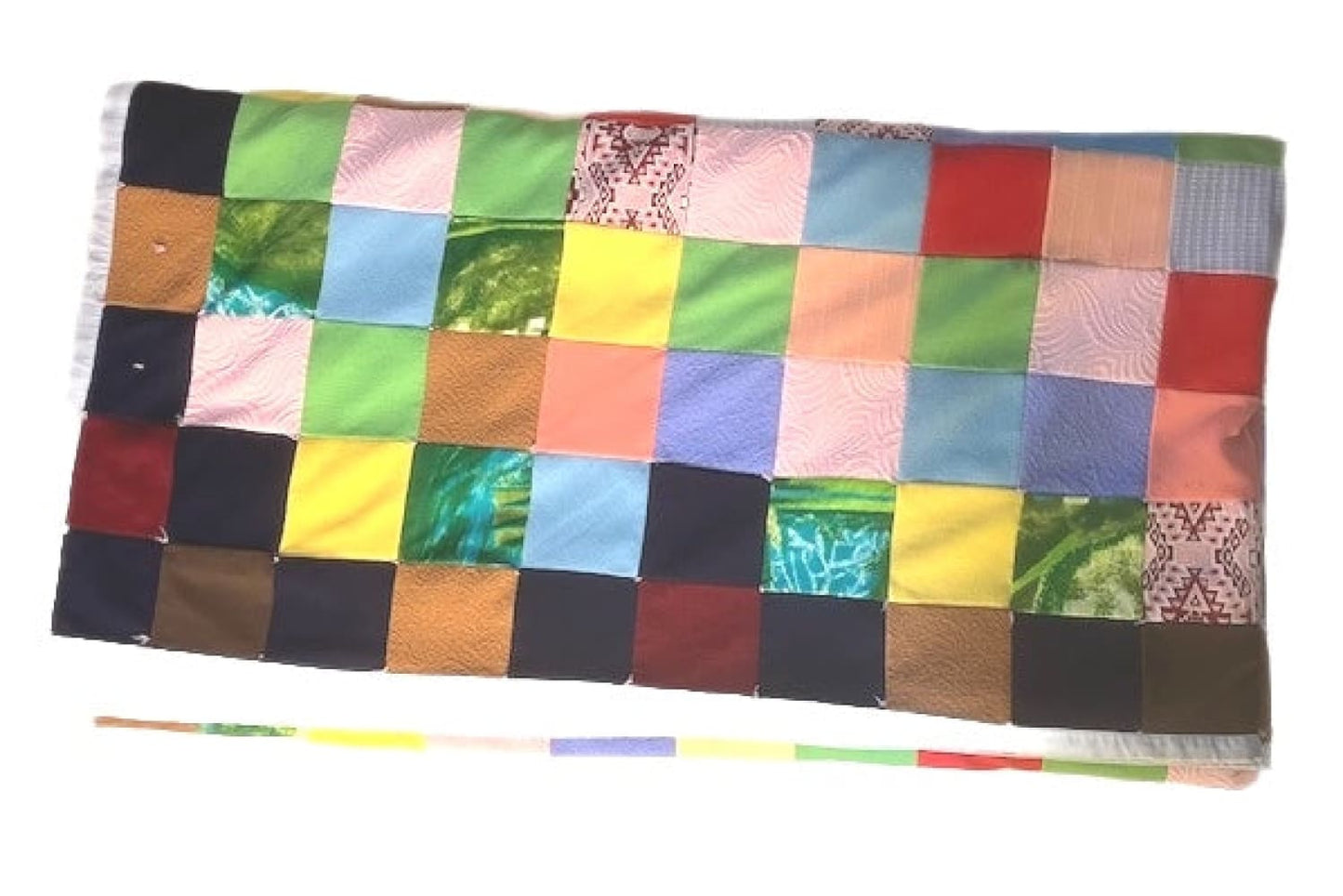 A vibrantly colored patchwork blanket composed of numerous square fabric swatches.