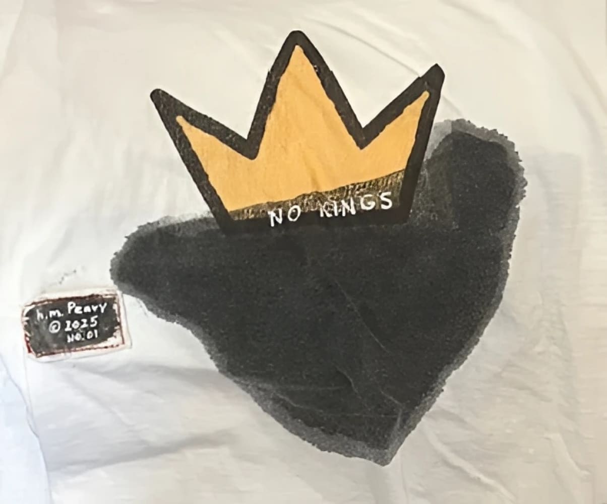 White t-shirt with black heart and gold crown design, ’no kings’ text