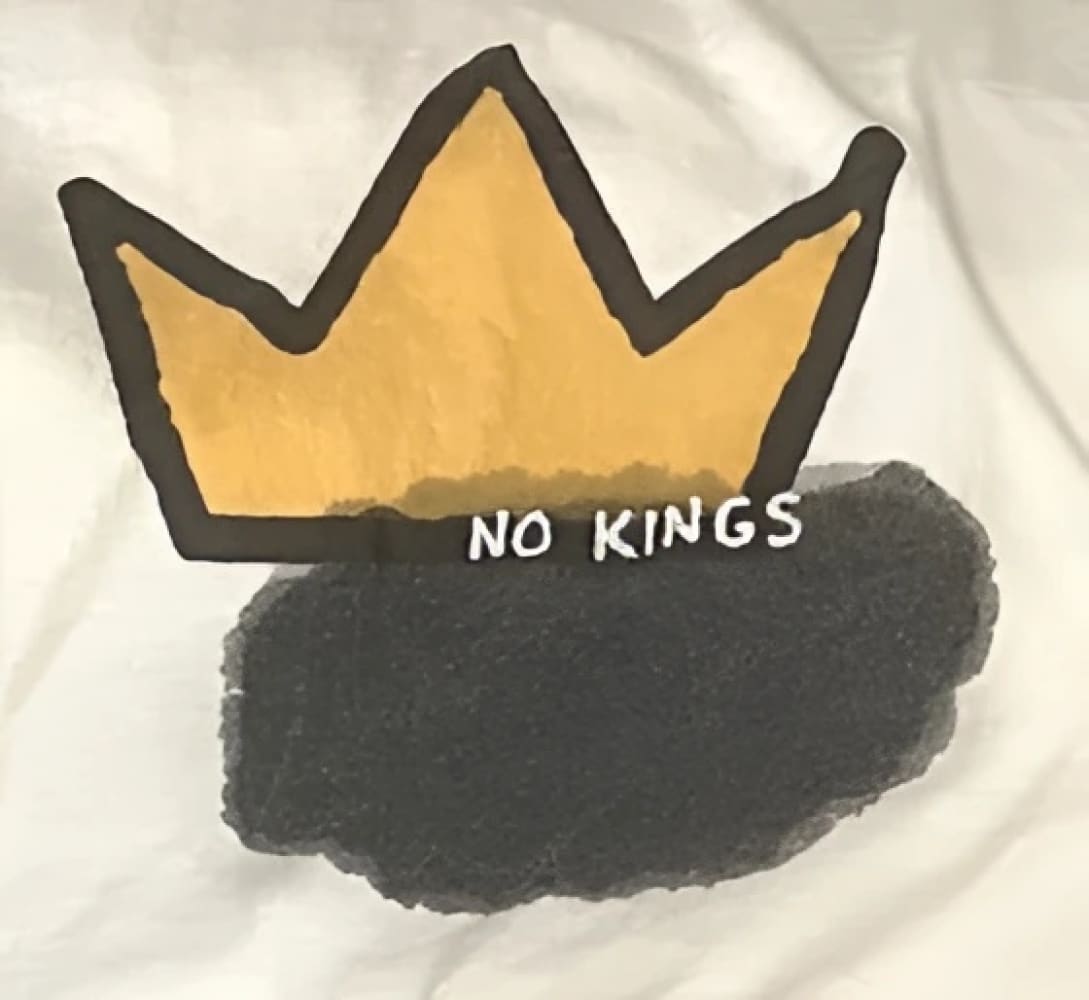 Yellow crown t-shirt with black cloud design.