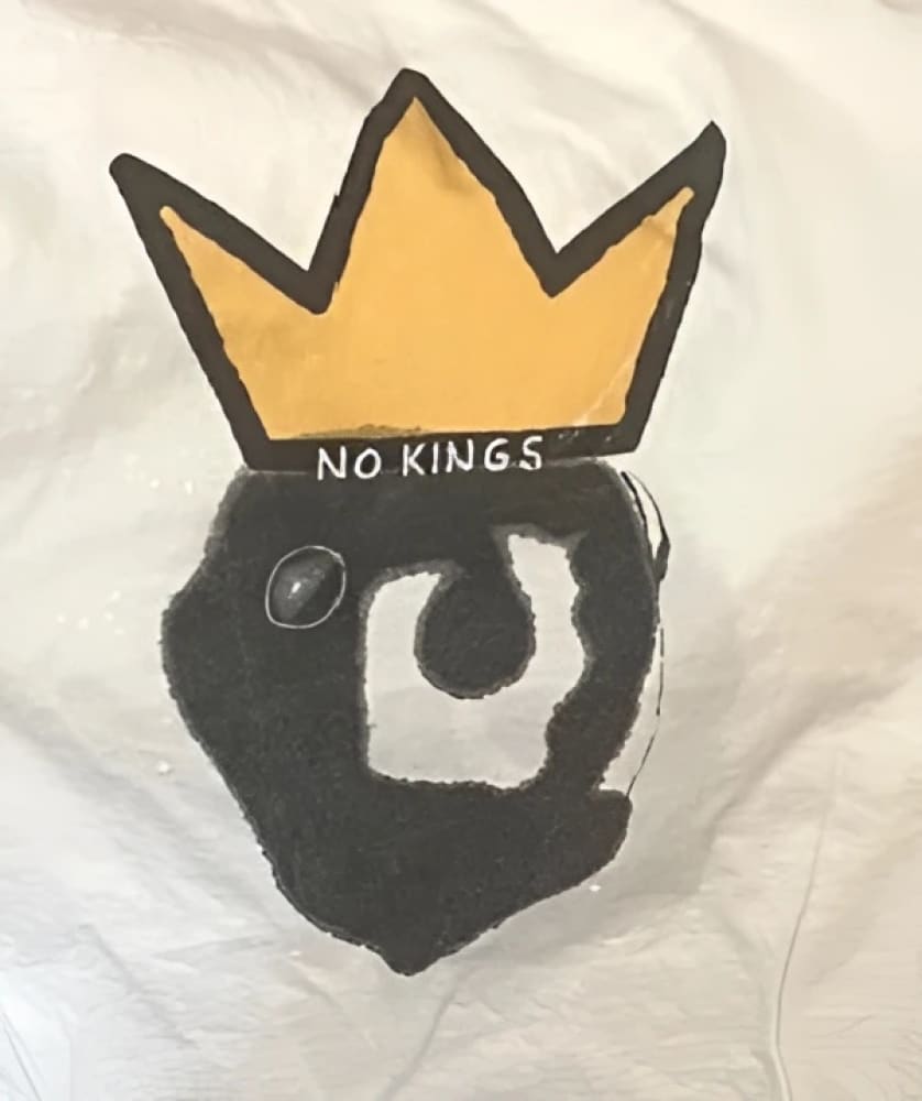 Yellow crown with black and white design on a white background.