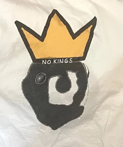 Yellow crown with black and white design on a white background.